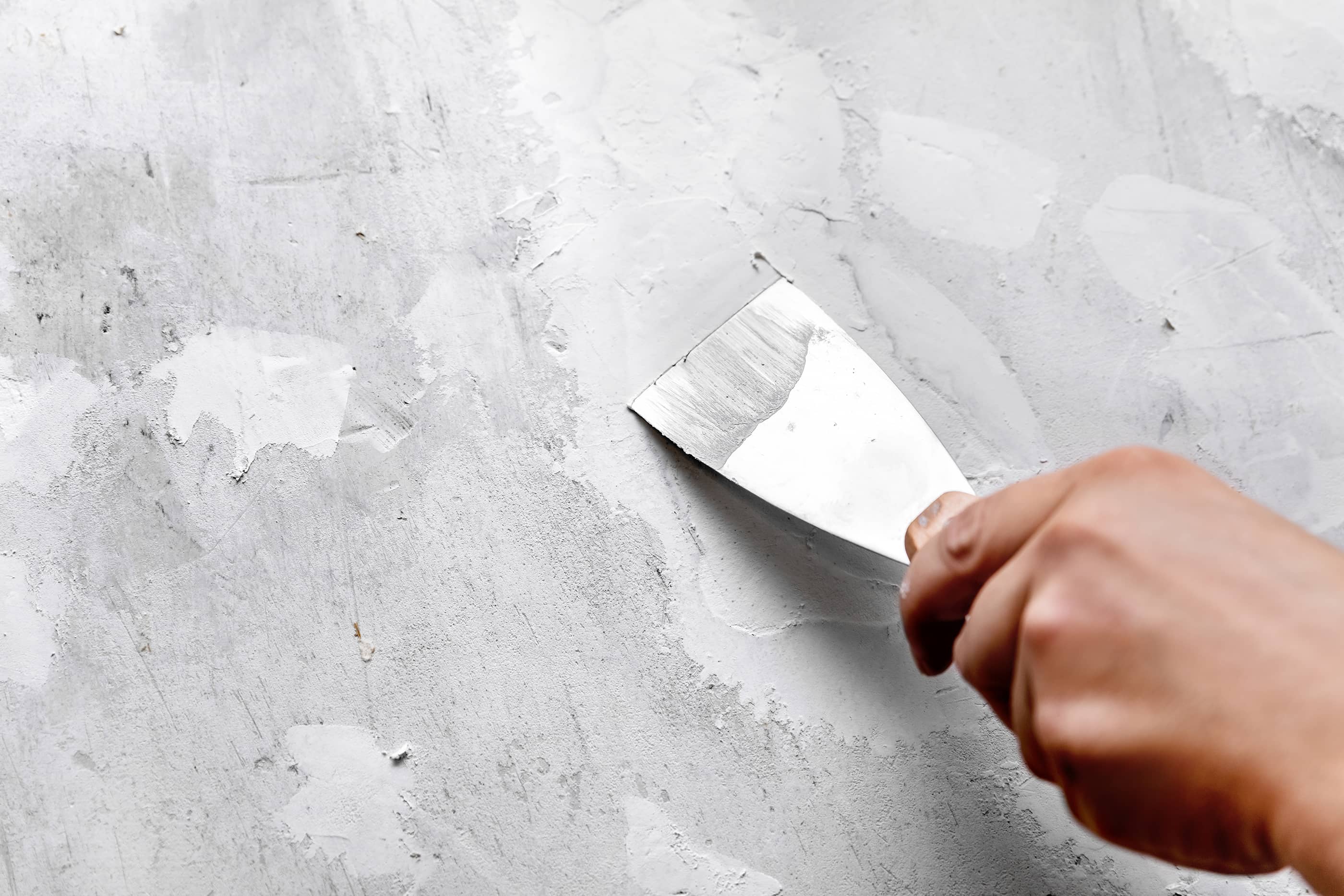 How to fix a hole in your wall.  2 Use the putty knife to apply spackle around the hole